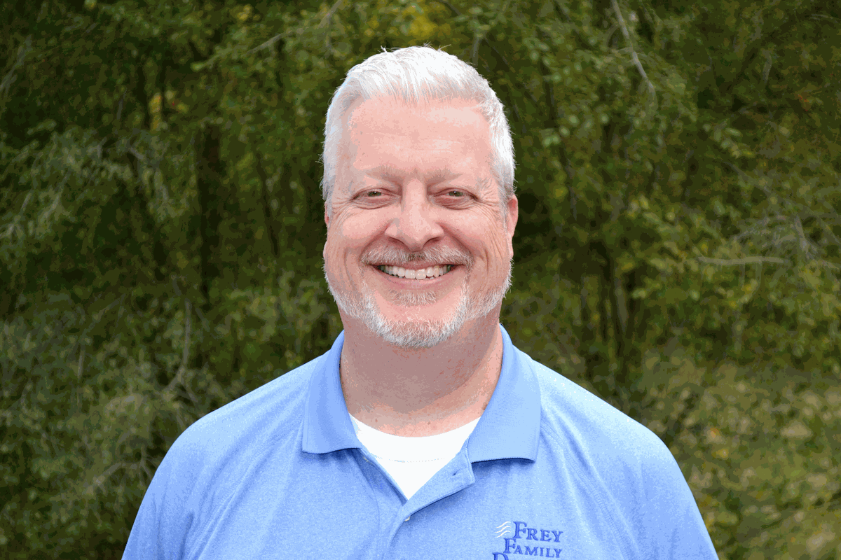 Dr. John Frey smiling outdoors